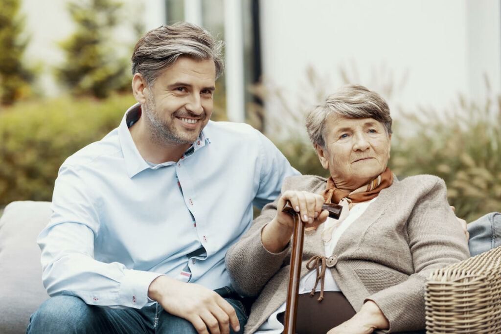 Vantage Pointe Village | senior woman and her son sitting outside on a bench