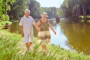 Senior couple walking by the river